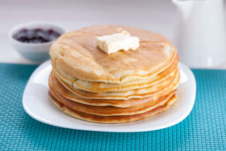 Delicious sweet American pancakes on a plate with fresh fruits and addons.の写真素材