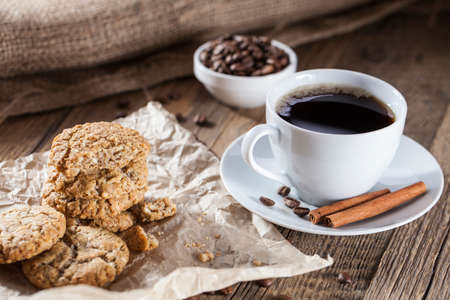Delicious coffee with sweets on a wooden table, studio shootの写真素材