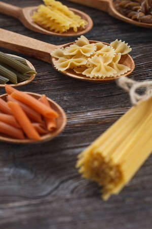 A set of raw pasta on a wooden table. Studio Shotの写真素材
