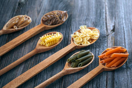 A set of raw pasta on a wooden table. Studio Shotの写真素材