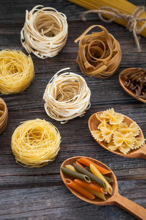A set of raw pasta on a wooden table. Studio Shot