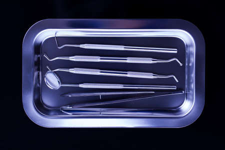 Professional dental tools in a sterile medical light