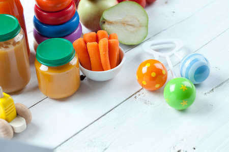 healthy ready-made baby food on a wooden table.の写真素材