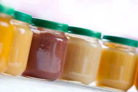 healthy ready-made baby food on a wooden table.の写真素材