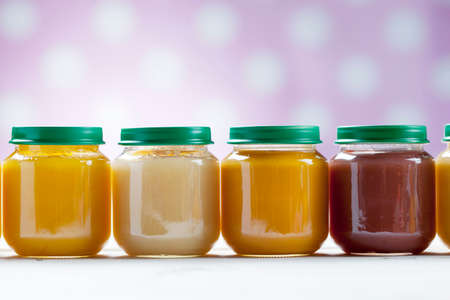 healthy ready-made baby food on a wooden table.