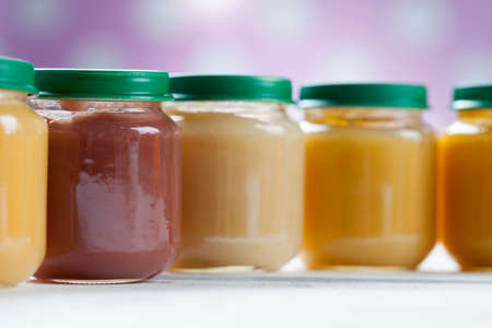 healthy ready-made baby food on a wooden table.の写真素材