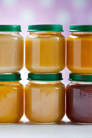 healthy ready-made baby food on a wooden table.の写真素材
