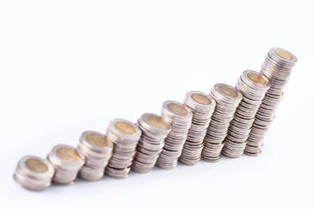 Financial concept with piggy bank, pile of money on white backgroundの写真素材