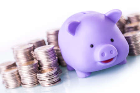Financial concept with piggy bank, pile of money on white backgroundの写真素材