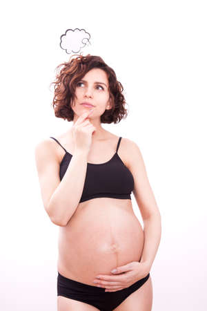 Pregnant woman thinks about her baby. Isolated on white backgroundの写真素材