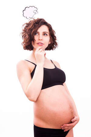 Pregnant woman thinks about her baby. Isolated on white backgroundの写真素材