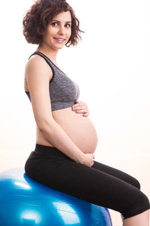 Young pregnant woman exercises with the ball.の写真素材
