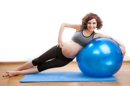 Young pregnant woman exercises with the ball.の写真素材