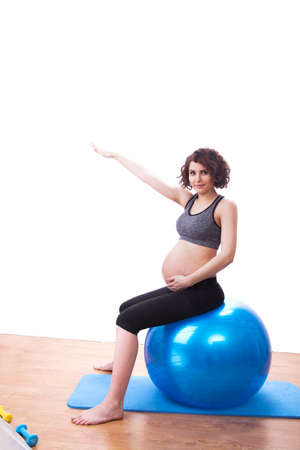 Young pregnant woman exercises with the ball.の写真素材