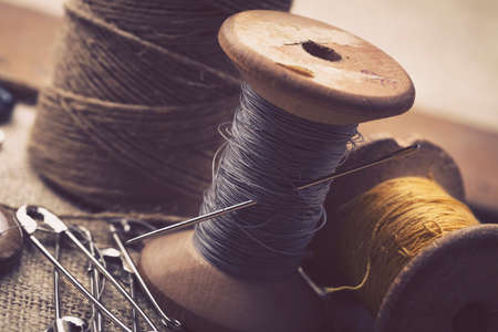 Sewing instruments, threads, needles, bobbins and materials. Studio photoの写真素材