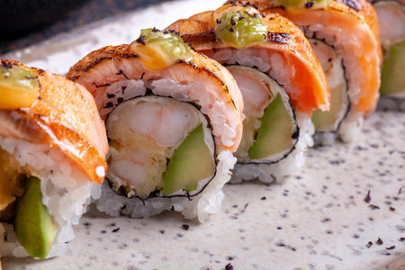 sushi roll with salmon, avocado, cucumber and cream cheeseの写真素材