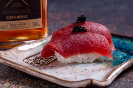 Tuna nigiri sushi with black caviar on a plate.の写真素材