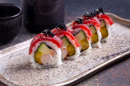 Sushi roll with salmon, cucumber and red caviar.の写真素材