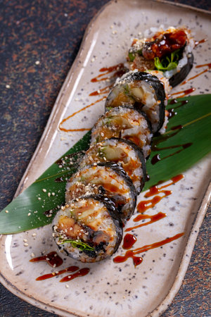 Sushi roll with eel, nori, cucumber and sesame seedsの写真素材