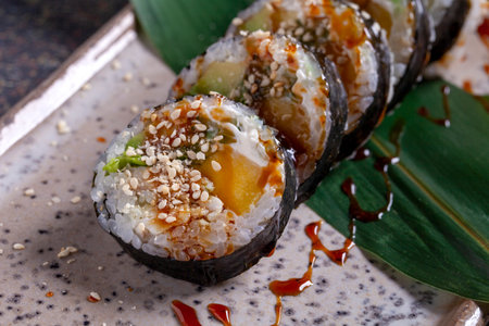 Sushi roll with eel, cucumber and sesame seedsの写真素材