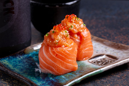 Salmon Sushi - Japanese food style on black slate background.の写真素材