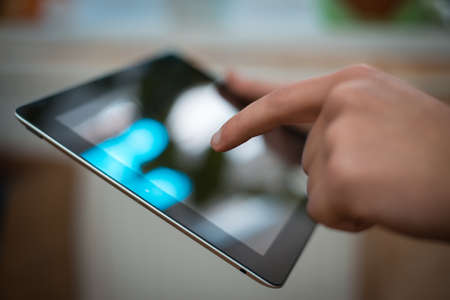 Close up of male hand using digital tablet