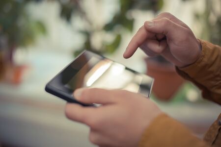Close up of male hand using digital tablet