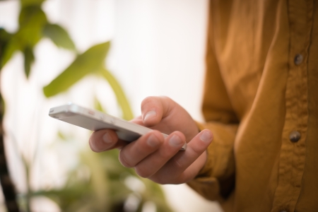 Close up of a man using mobile smart phone