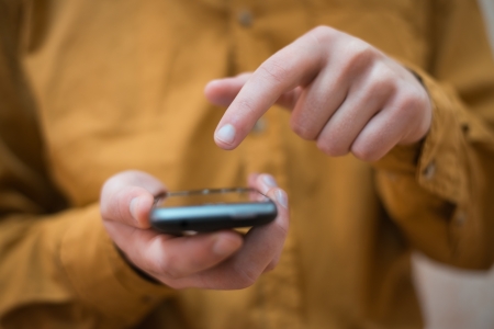 Close up of a man using mobile smart phone