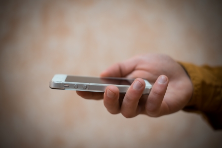 Close up of a man using mobile smart phoneの写真素材