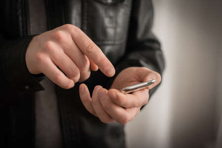 Close up of a man using mobile smart phoneの写真素材