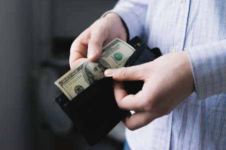 Man gets $ 100 from her purseの写真素材