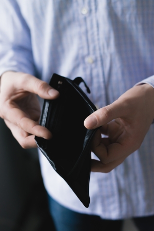 Man holding an empty walletの写真素材