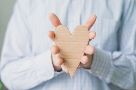 A man holds a heart in his handの写真素材