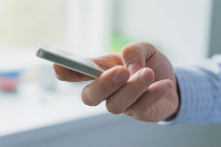 A man uses a smartphone.
