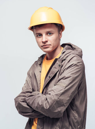 Man worker in a yellow helmet