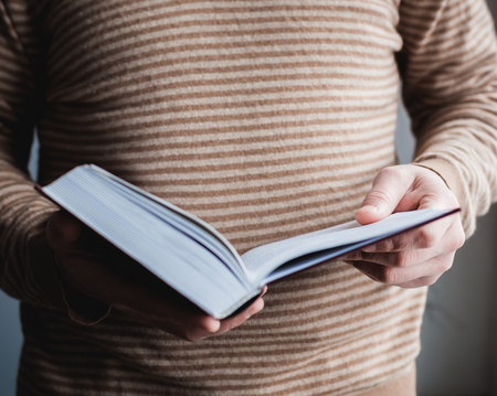 Man reading. Book in his hands.の写真素材