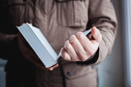Man reading. Book in his hands.