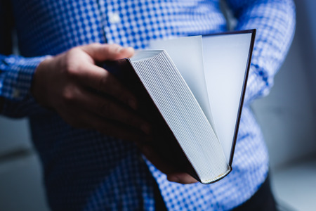 Man reading. Book in his hands.