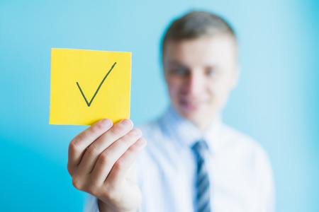 man holding a sign character and the icon for the approved concept design and web graphics.の写真素材