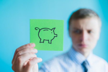 Hands holding piggy bankの写真素材