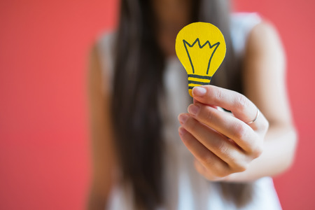 drawing light bulb icon in the handの写真素材