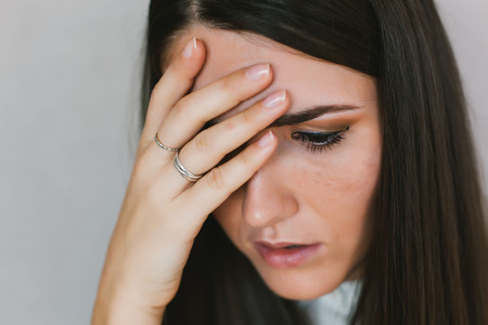 portrait of a young girl headacheの写真素材