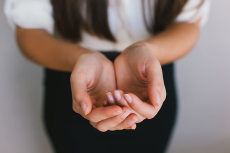 close up of womans cupped hands showing somethingの写真素材