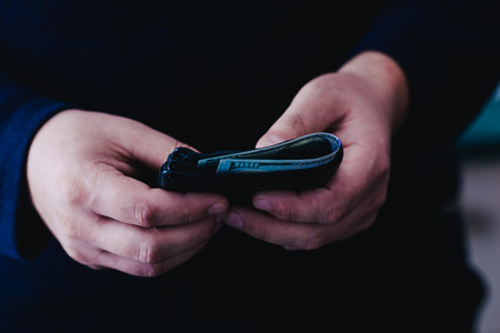 Purse with dollars in their hands.の写真素材