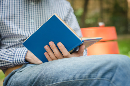 Man reading. Book in his hands.の写真素材