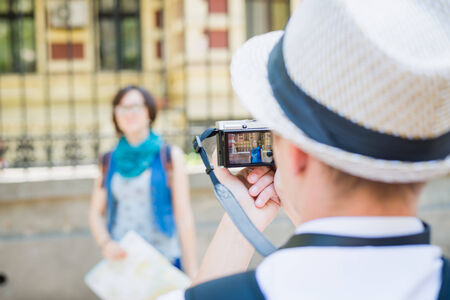 Happy tourist girl posing for photoの写真素材