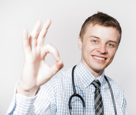 doctor with a stethoscope  gesture shows okayの写真素材