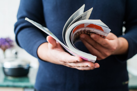 Man reads magazineの写真素材