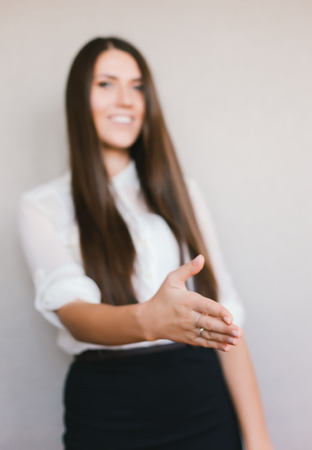 Beautiful business woman giving a handshakeの写真素材